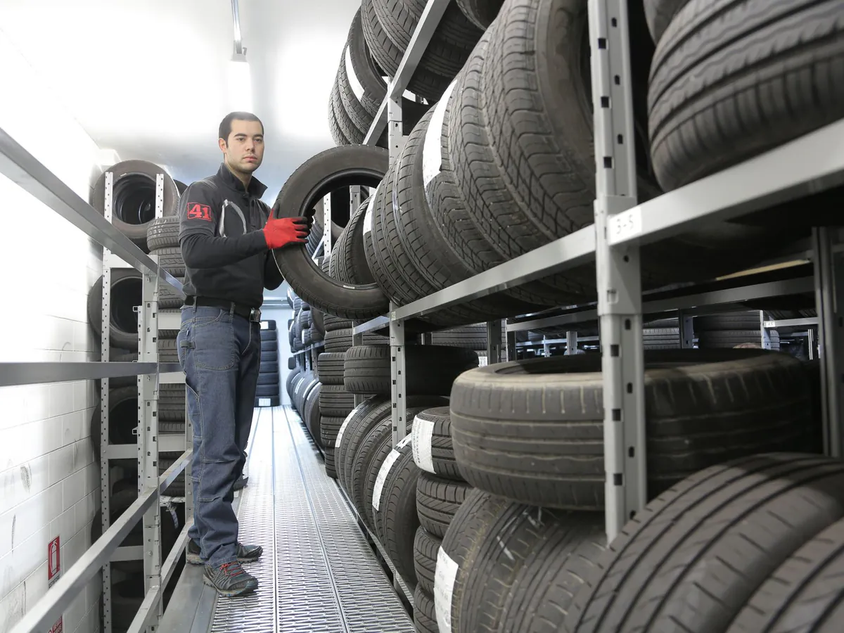 Racking stacked with car tyres in a store room.